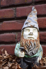 Gnome Statue by a Brick Wall