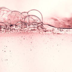 Cosmetic pink water gel splash with bubbles texture background