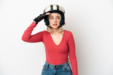 Young caucasian woman with a motorcycle helmet isolated on white background doing surprise gesture while looking to the side