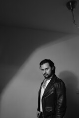 Portrait of bearded handsome confident man. Vertical. Black and white photo.