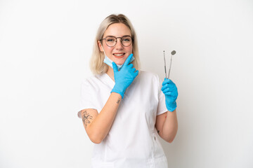 Dentist caucasian woman holding tools isolated on white background happy and smiling