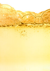 Splash of orange cosmetic moisturizer water toner or emulsion herbal extract with bubbles abstract background
