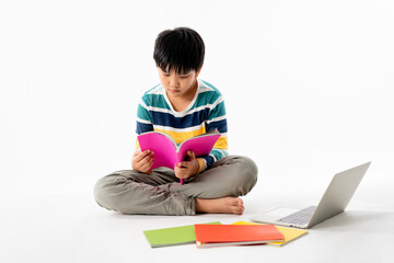 Portrait of Happy asian boy on floor with laptop and books isolated on white background, Education...