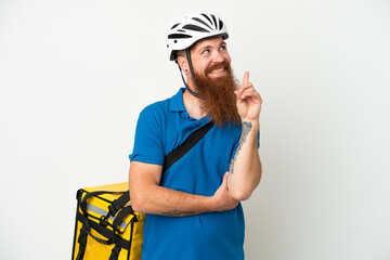Young reddish caucasian man with thermal backpack isolate don white background pointing up a great idea