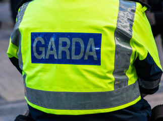 Garda inscription on jacket of policeman