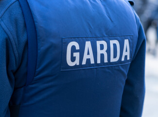 Garda inscription on jacket of policeman