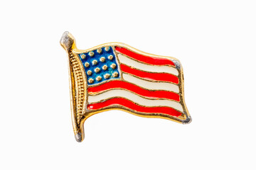 Antique enameled American flag pin on white background.