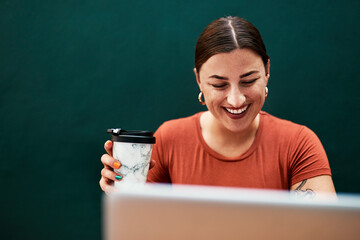 Coffee gets me through the busy day. Cropped shot of an attractive young businesswoman sitting...