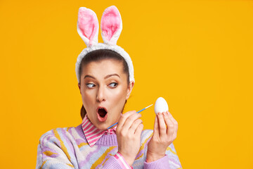 Studio shots of woman over yellow background easter style