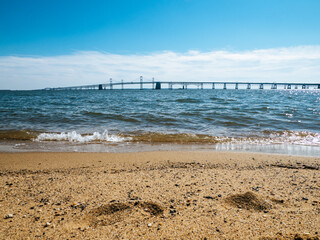 Beach at Sandy Point State Park in Annapolis, USA with the Chesapeake Bay Bridge in the background