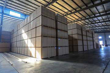 Particleboard products are stacked in the warehouse in a factory in North China