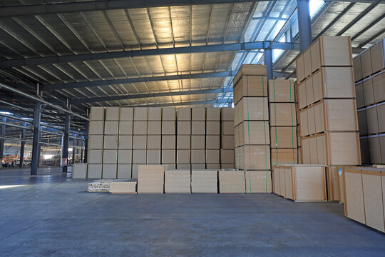 Particleboard products are stacked in the warehouse in a factory in North China