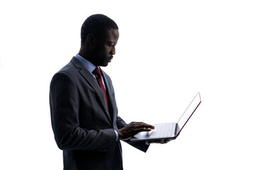 Silhouette of African businessman using a laptop PC.