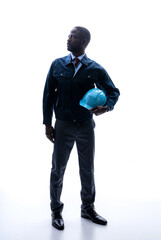 Silhouette of African engineer looking up.