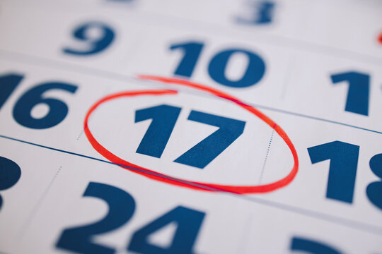 Marking the seventeenth 17 day of a month in the calendar with a red marker. Note of the calendar, significant date. Signing the day on the calendar. Reminder mark on the eighteenth 18 day of month.  - Powered by Adobe