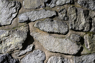 Rustic stone pillar on a sunny day as an abstract background
