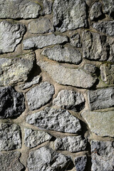 Rustic stone pillar on a sunny day as an abstract background
