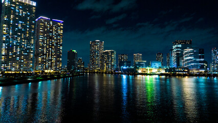 Night view of a high-rise condominium along an urban river_28