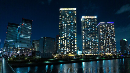 Night view of a high-rise condominium along an urban river_30