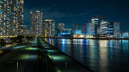 Night view of a high-rise condominium along an urban river_35