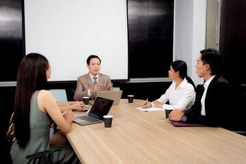 Young businessman or executive meeting conference with employee for planning and strategy of marketing about financial at the office, colleague and team group brainstorming, business concept.