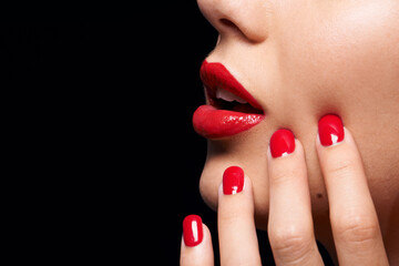 Naklejka premium A splash of COLOR. A cropped studio shot of a beautiful model wearing red lipstick and nailpolish.
