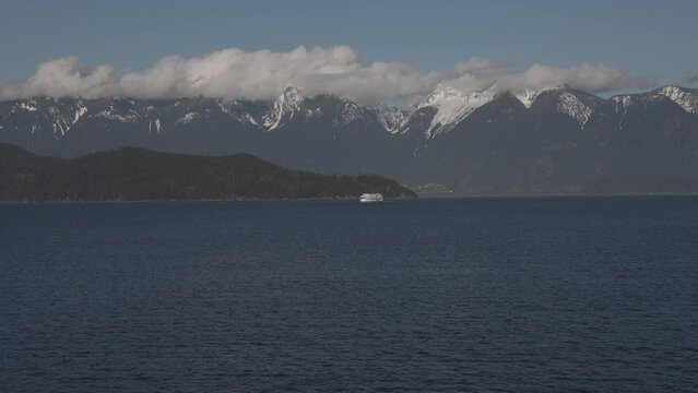 BC ferry boat navigating on sea water with mountains in background, British Columbia. Vancouver in Canada. Aerial drone view