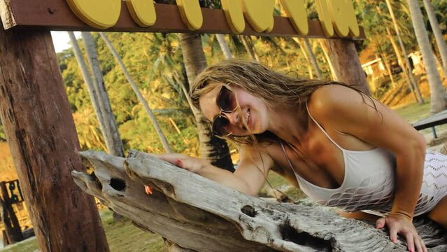 The minx hot alluring girl is posing on a tree, she wants you right away. The licentious woman provocative fervently twists her buttocks.