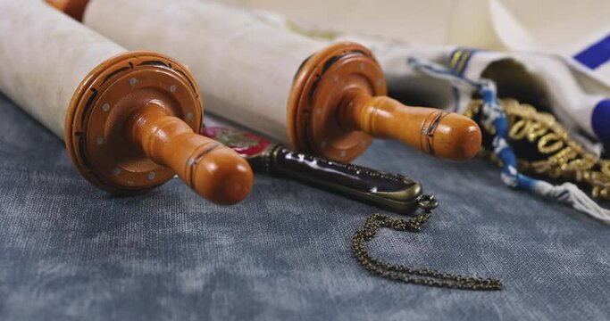 Jewish Orthodox holidays, during prayer items prayer shawl tallit with torah scroll in a synagogue