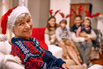 Theres no way Im wearing those antlers. A happy grandmother with her family on Christmas Eve.