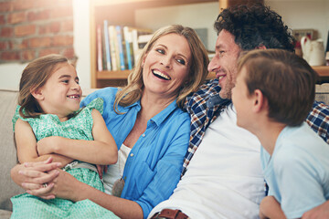 Time is the most valuable thing to spend on family. Shot of a happy family relaxing on the sofa together at home.