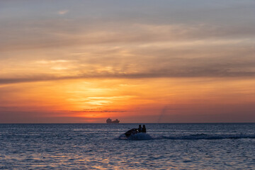 Fototapeta na wymiar jet ski in a sunset at sea