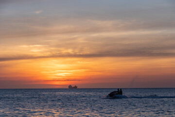 jet ski in a sunset at sea