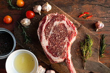 Sliced grilled thai steak served on white plate with grilled sliced lemon, tomatoes, garlic