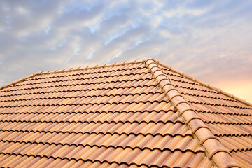 Roof tiles and sky sunlight.Roofing Contractors concept Installing House roof.