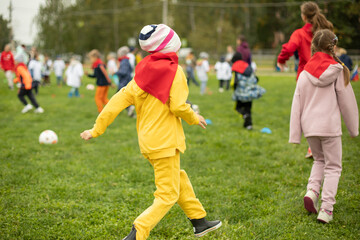 Children at sports tournament. Playing in park. Schoolchildren play sports. Health Day in Russia.