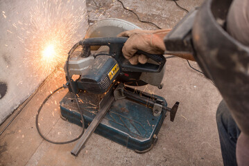 Using a Abrasive Cutoff Machine or chop saw on the floor to cut a piece of steel square tube....