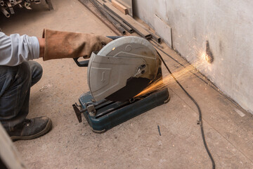 Using a Abrasive Cutoff Machine or chop saw on the floor to cut a piece of steel square tube....