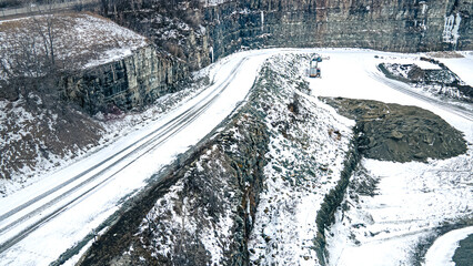 Snow covered gravel road at rock quarry