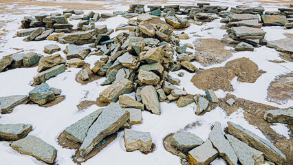 Stones collected at a rock quarry covered in snow