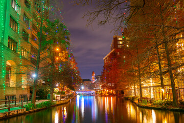 San Antonio River Walk near Navarro Street with Bexar County Courthouse at the background at night in downtown San Antonio, Texas, USA.