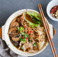 Homemade noodle meal. Bak Kut Teh Flavored Noodle Soup aka Chinese Herbal Soup Noodle in Clay Pot.