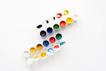 Flat composition a set of multi-colored paints in jars. Space for the text.