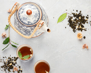 Obraz na płótnie Canvas Asian teapot with herbal tea on light background.