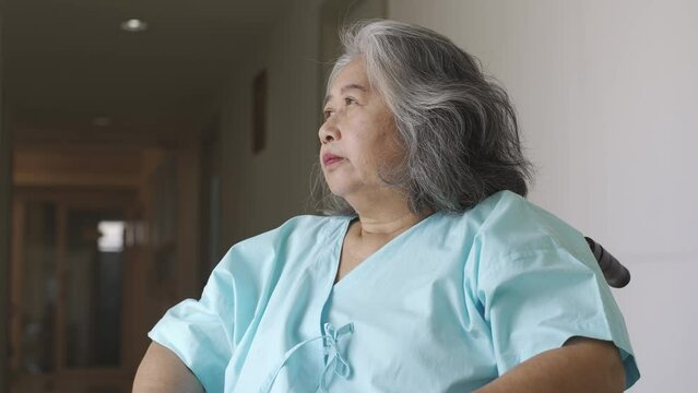 An Asian senior adult woman suffering from a mental disorder breakdown sickness, mental disorder concept, negative emotion, Alzheimer, depression and difficult life in the hospital situation concept