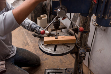 Drilling a hole into a piece of metal held with a pair of pliers. Using a heavy duty drill press...