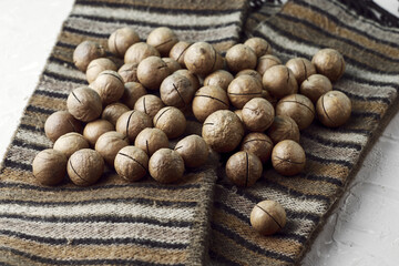 macadamia nuts on a canvas with a traditional African ornament