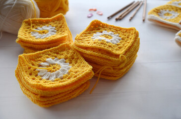 Crochet handmade granny square pattern, crocheting supplies, assorted colored wool yarn, hook, knitting crocheting