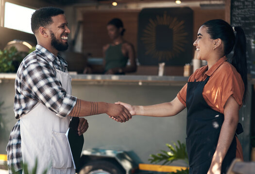 Welcome to the team. Shot of two young restaurant owners standing outside together and shaking hands.