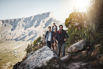 Obraz premium Following the trail. Full length shot of a group of friends walking along a mountain trail.